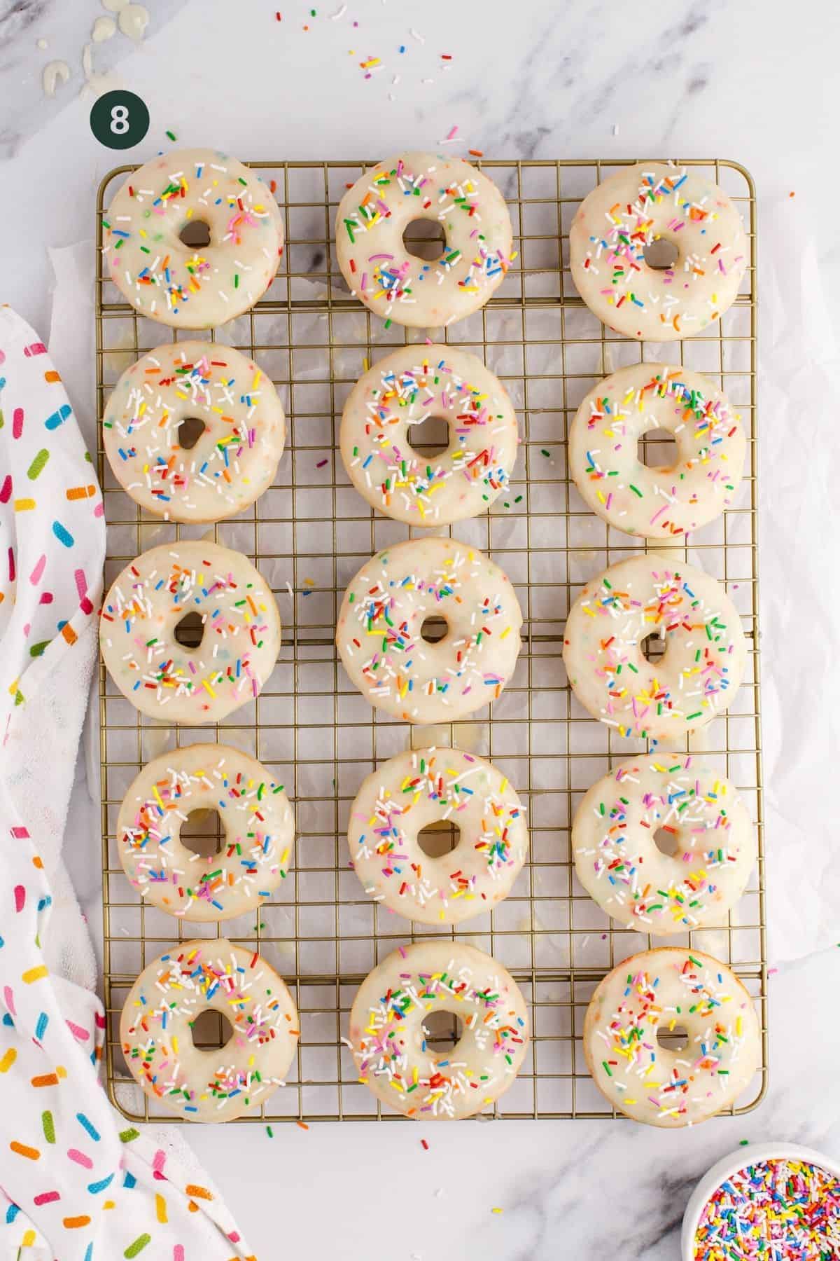 Frosted donuts with sprinkles on top.