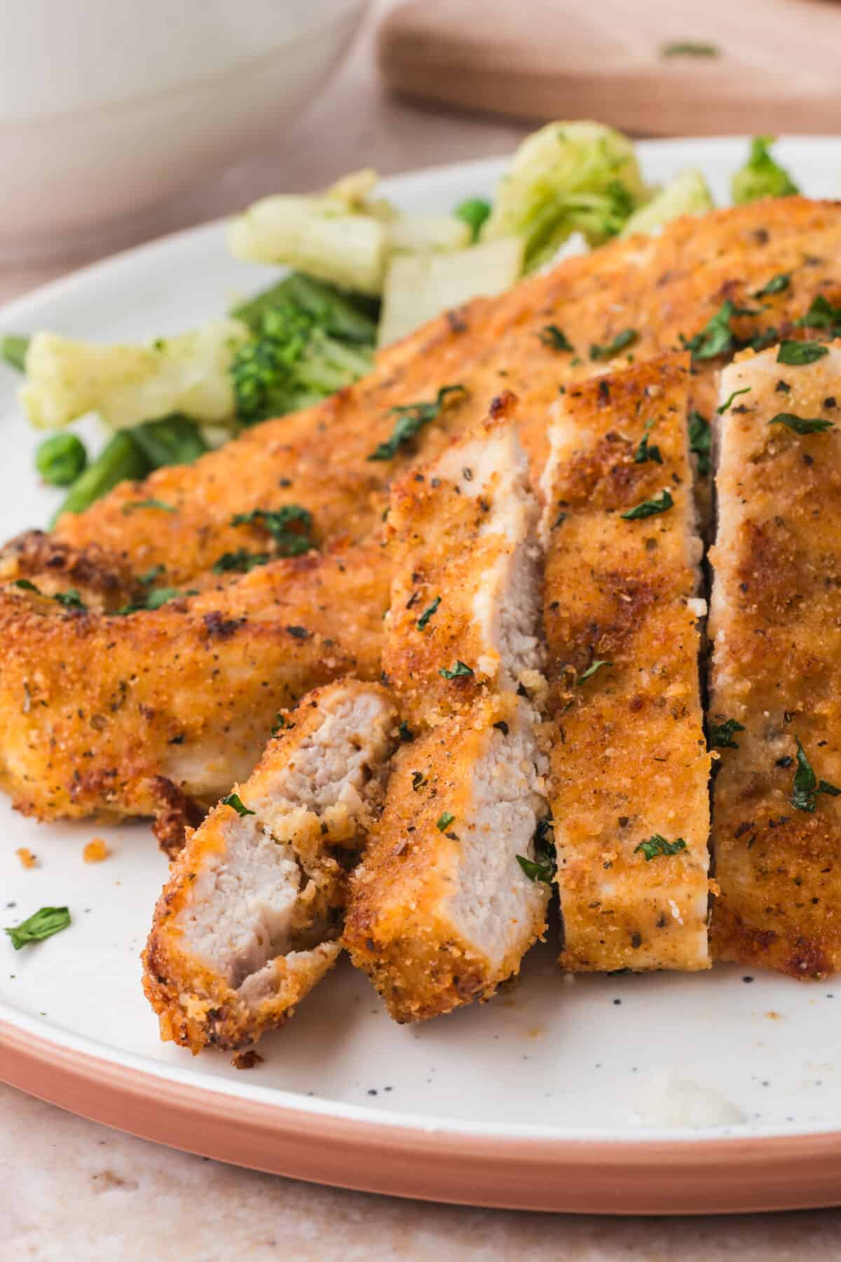 Sliced breaded chicken cutlets with broccoli. 