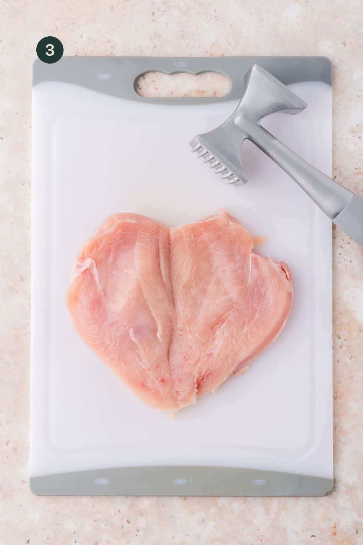 Butterflied chicken breast with a meat pounder to pound out to even thickness.
