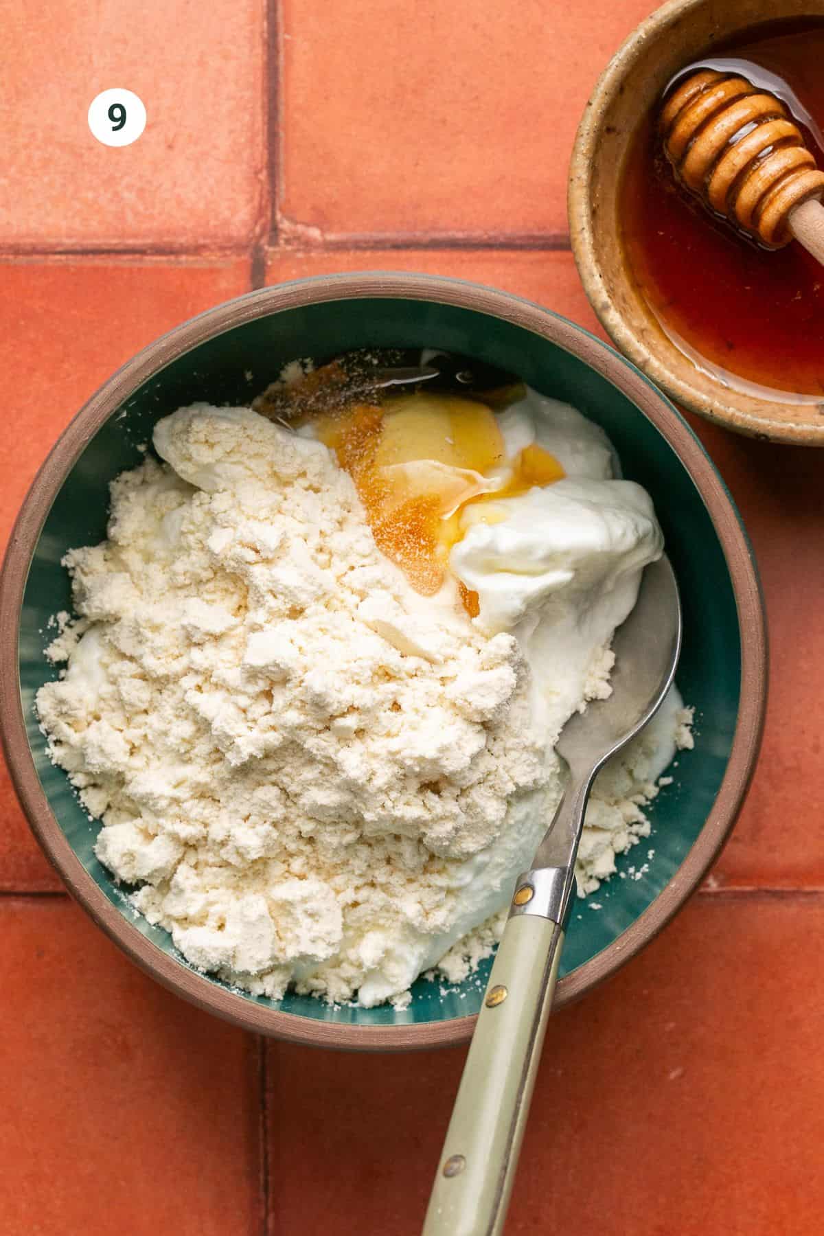 Greek yogurt, protein powder and honey in a mixing bowl. 