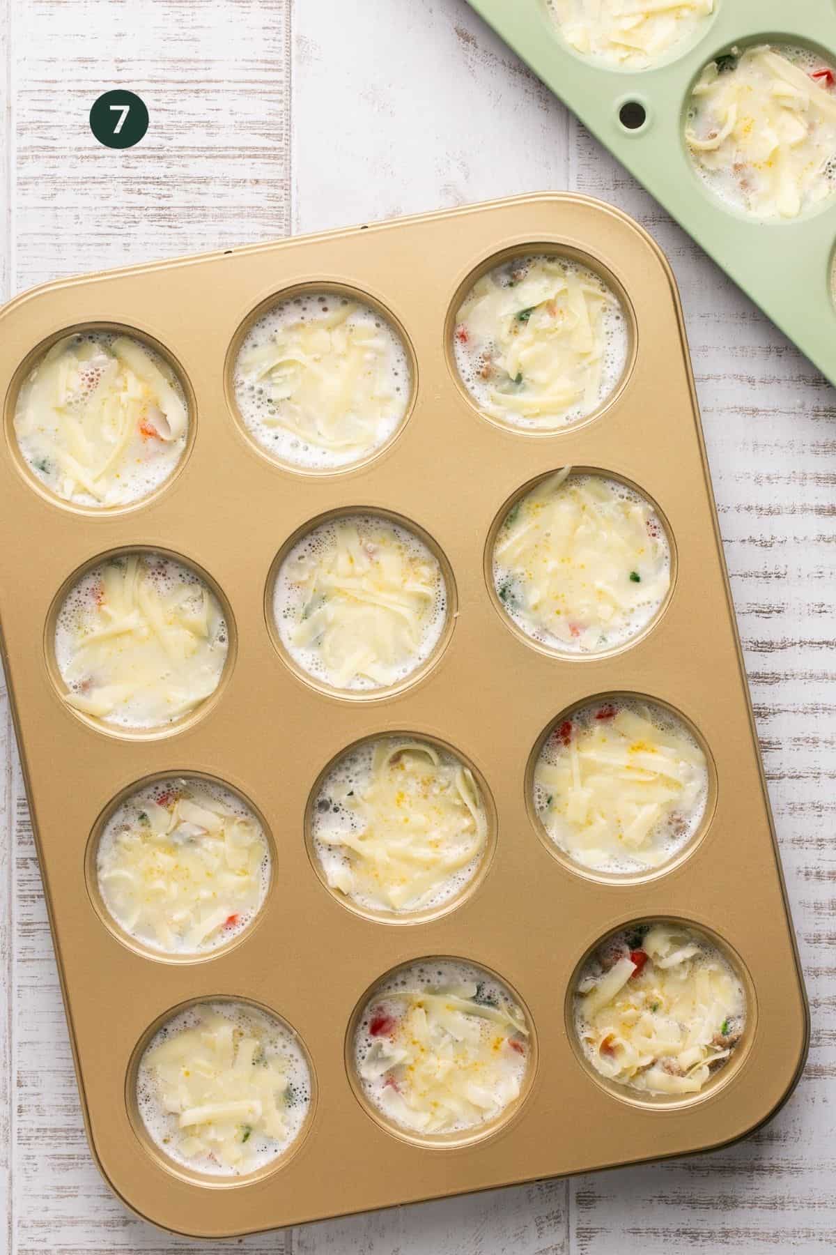 Cheese added to each muffin tin.