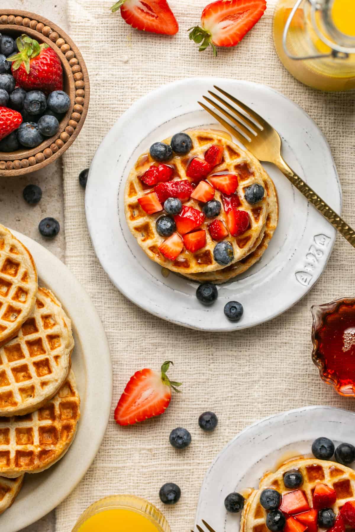 Plated waffles with berries and a fork. 