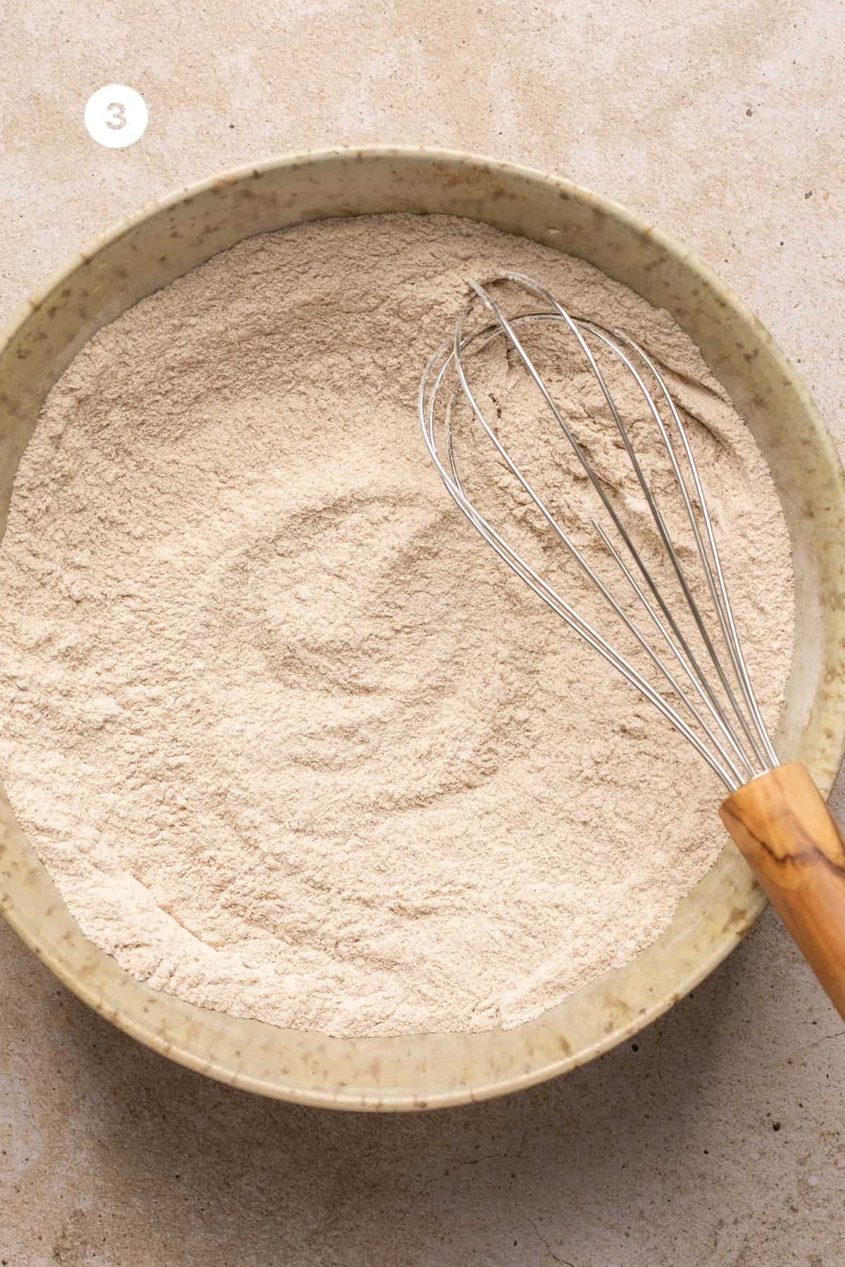 Salt, baking soda and whole wheat flour whisked together in a bowl. 