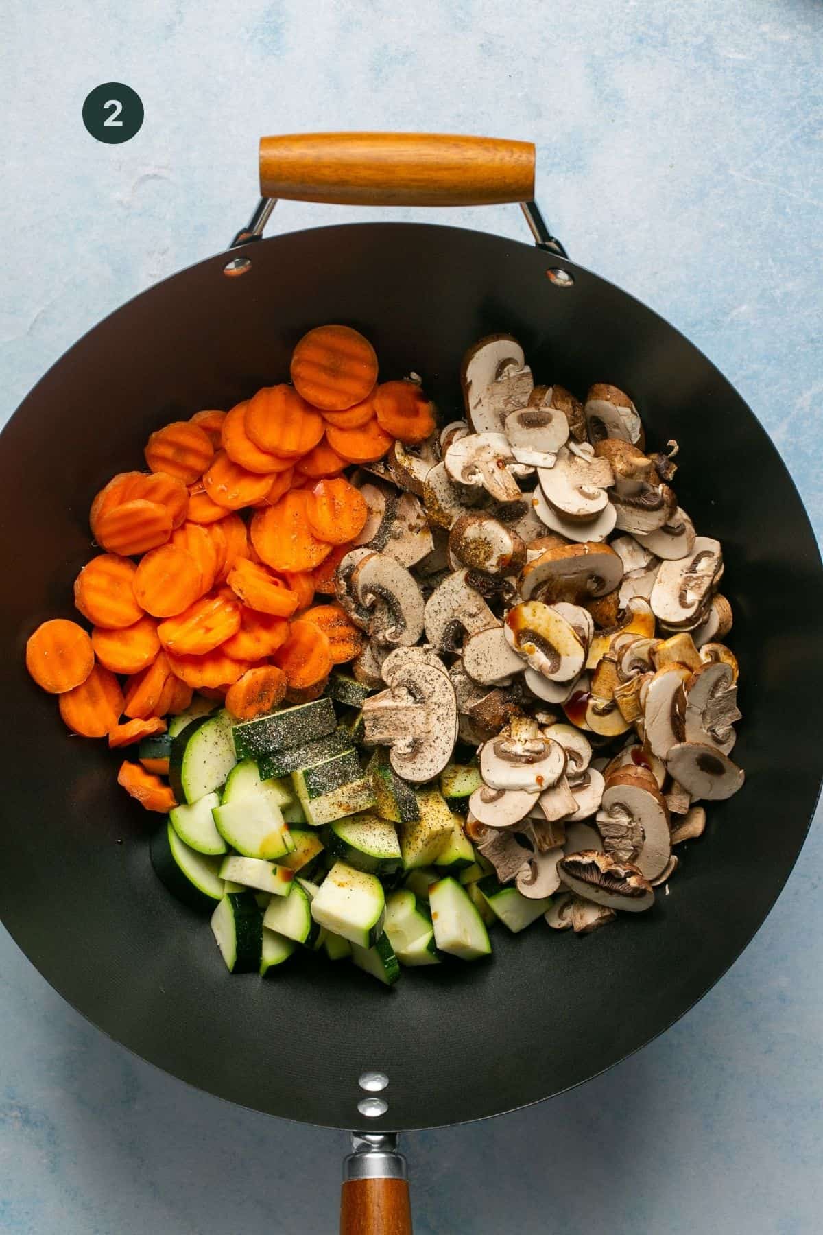 Chopped carrots, mushrooms zucchini, coconut aminos, olive oil salt and pepper in a large wok to sauté. 
