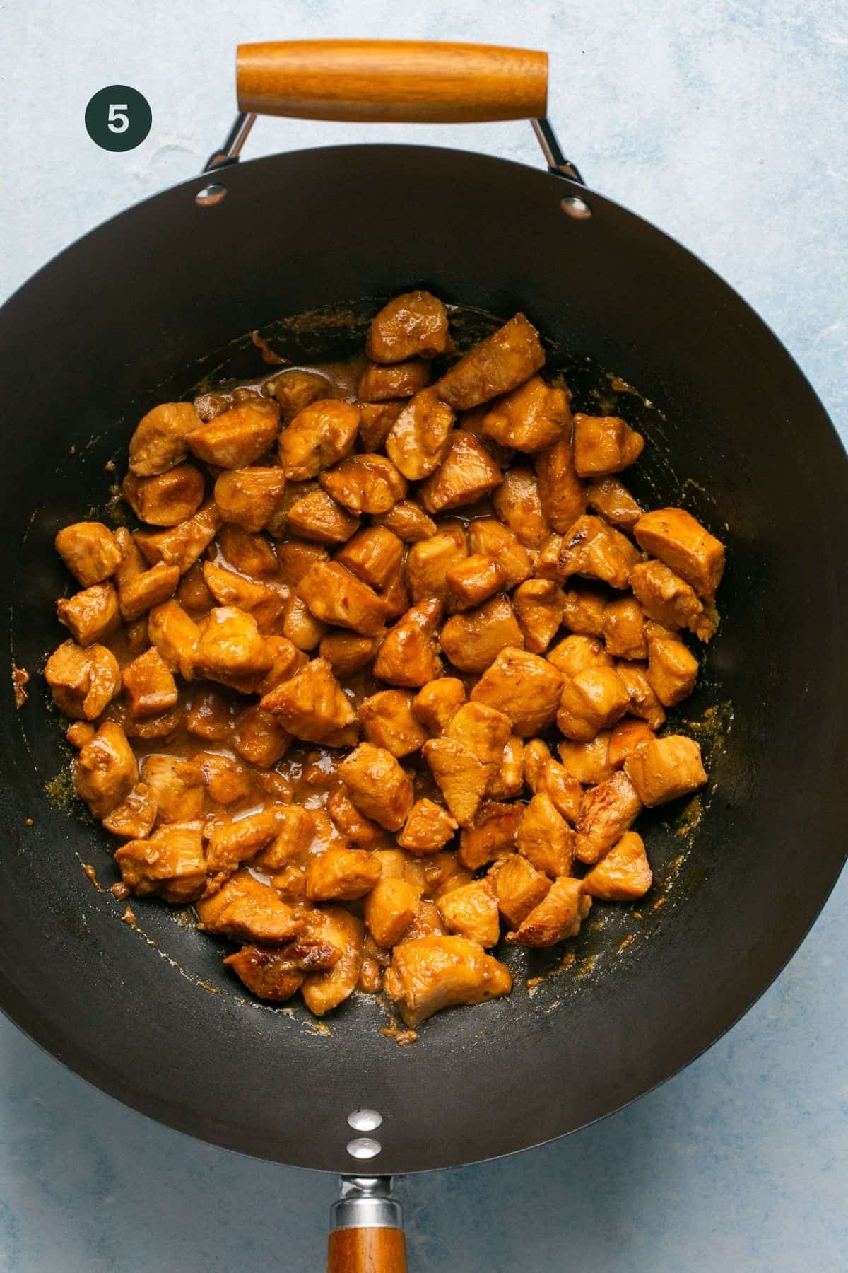 Fully cooked marinated chicken in the wok. 