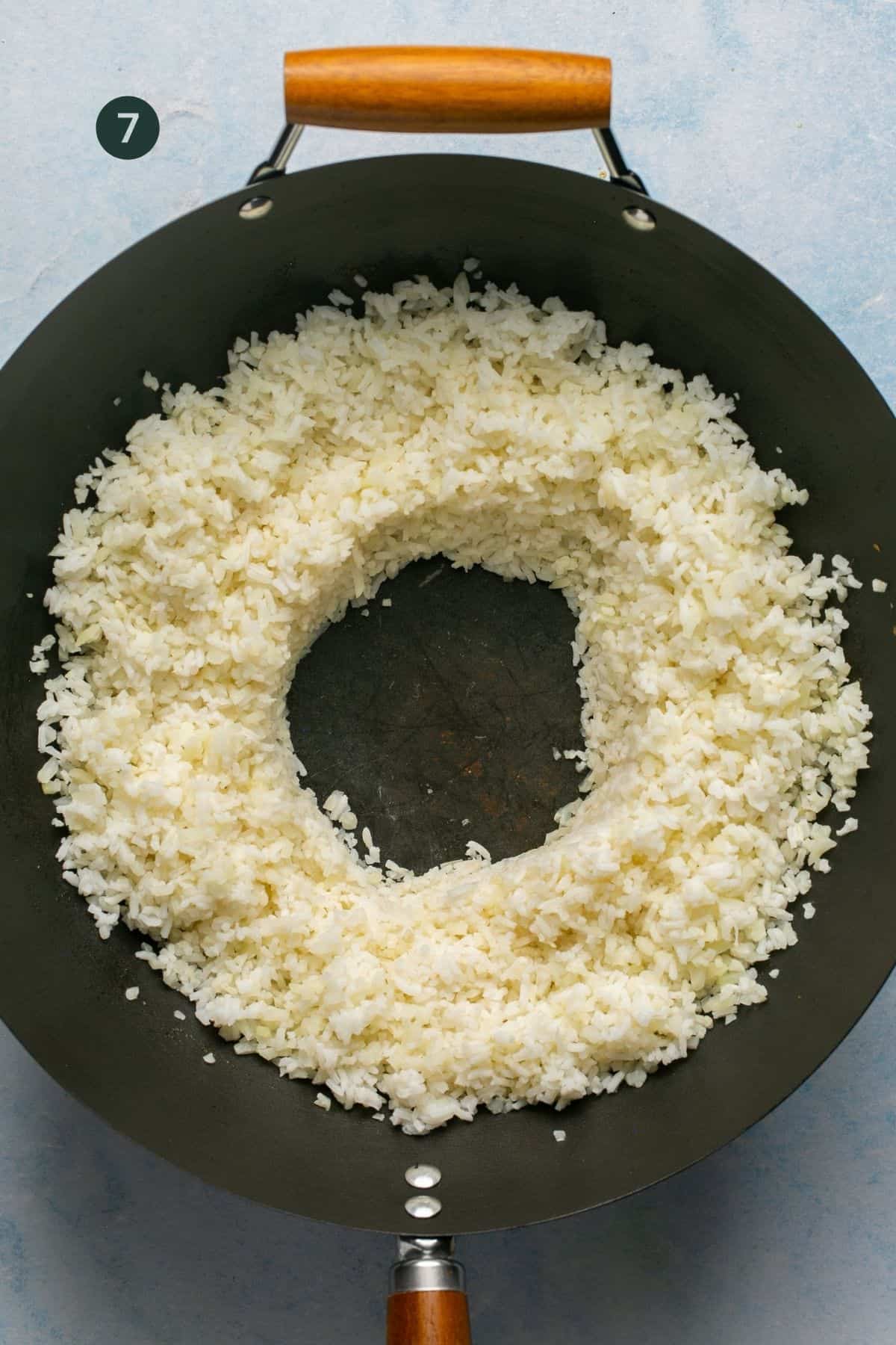 Rice and cauliflower rice combined and pushed to the edges to create a hole in the center. 