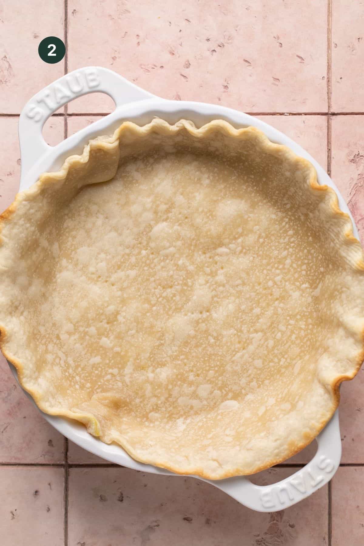 Baked, lightly browned pie crust in a pie dish. 