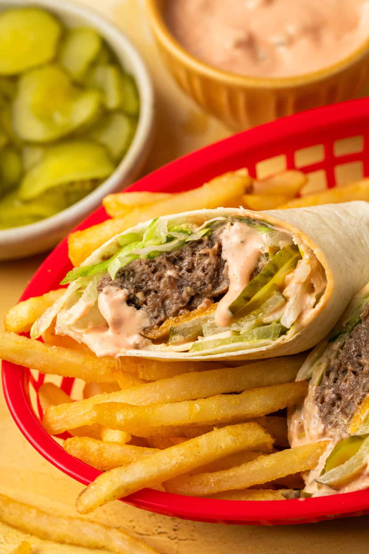 Big Mac wrap in a basket full of french fries. 
