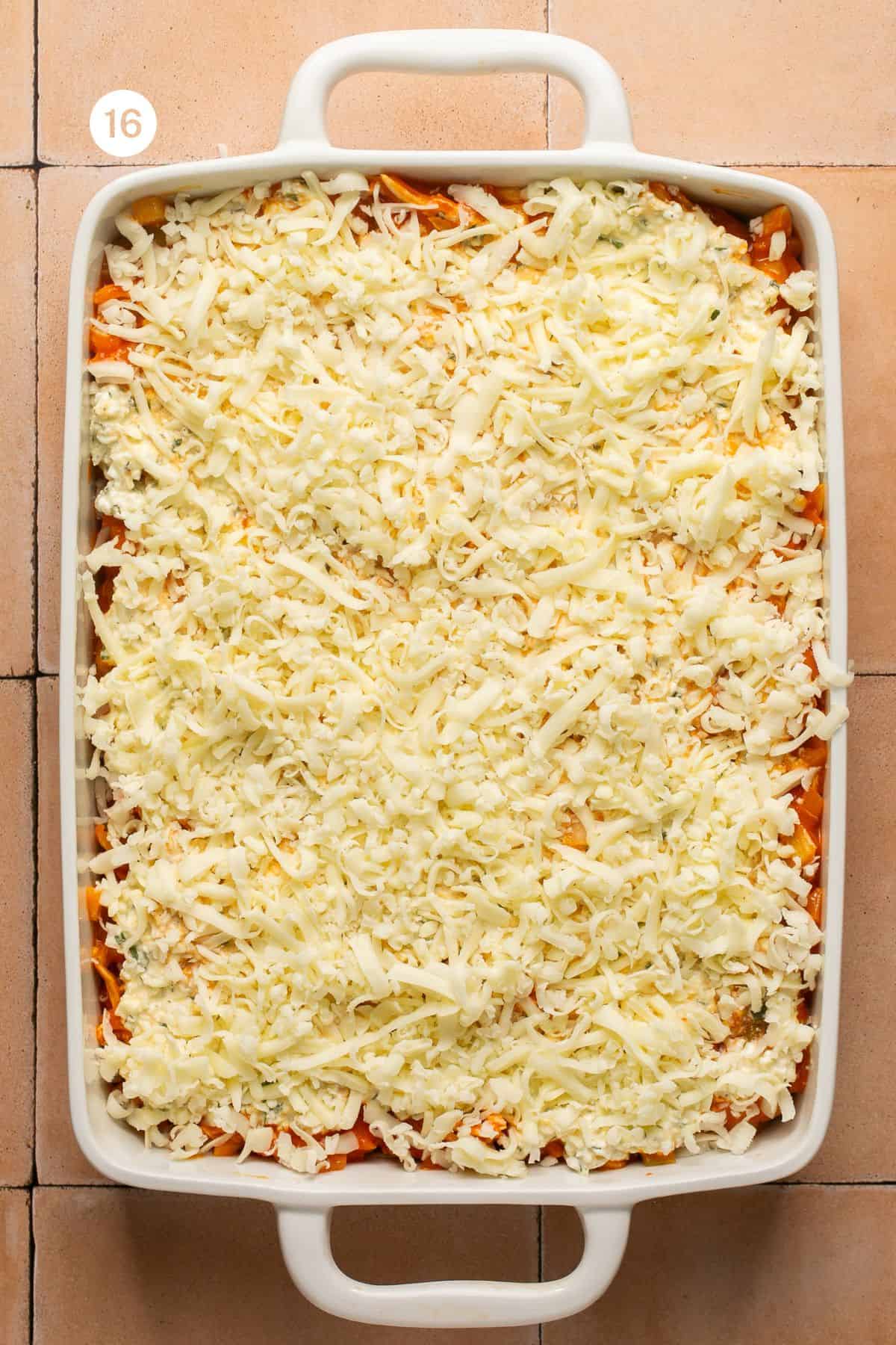 Layered buffalo lasagna topped with the final mozzarella cheese and ready for the oven. 