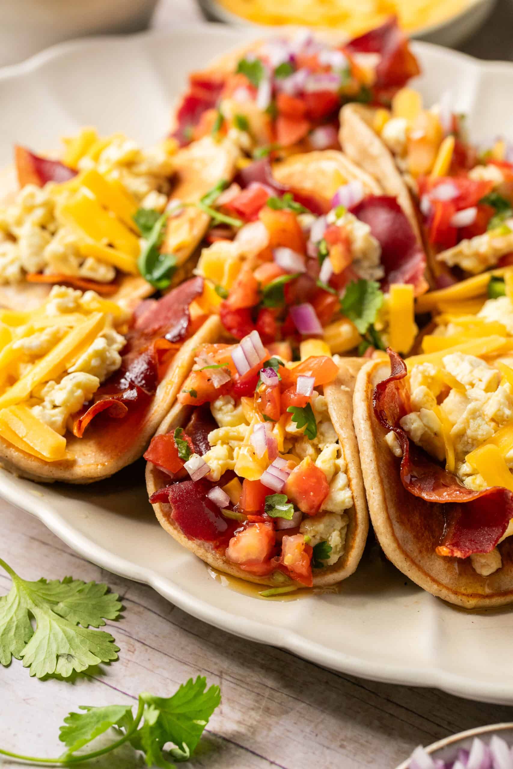 Pancake full of bacon, scrambled eggs, salsa, cheese and cilantro.