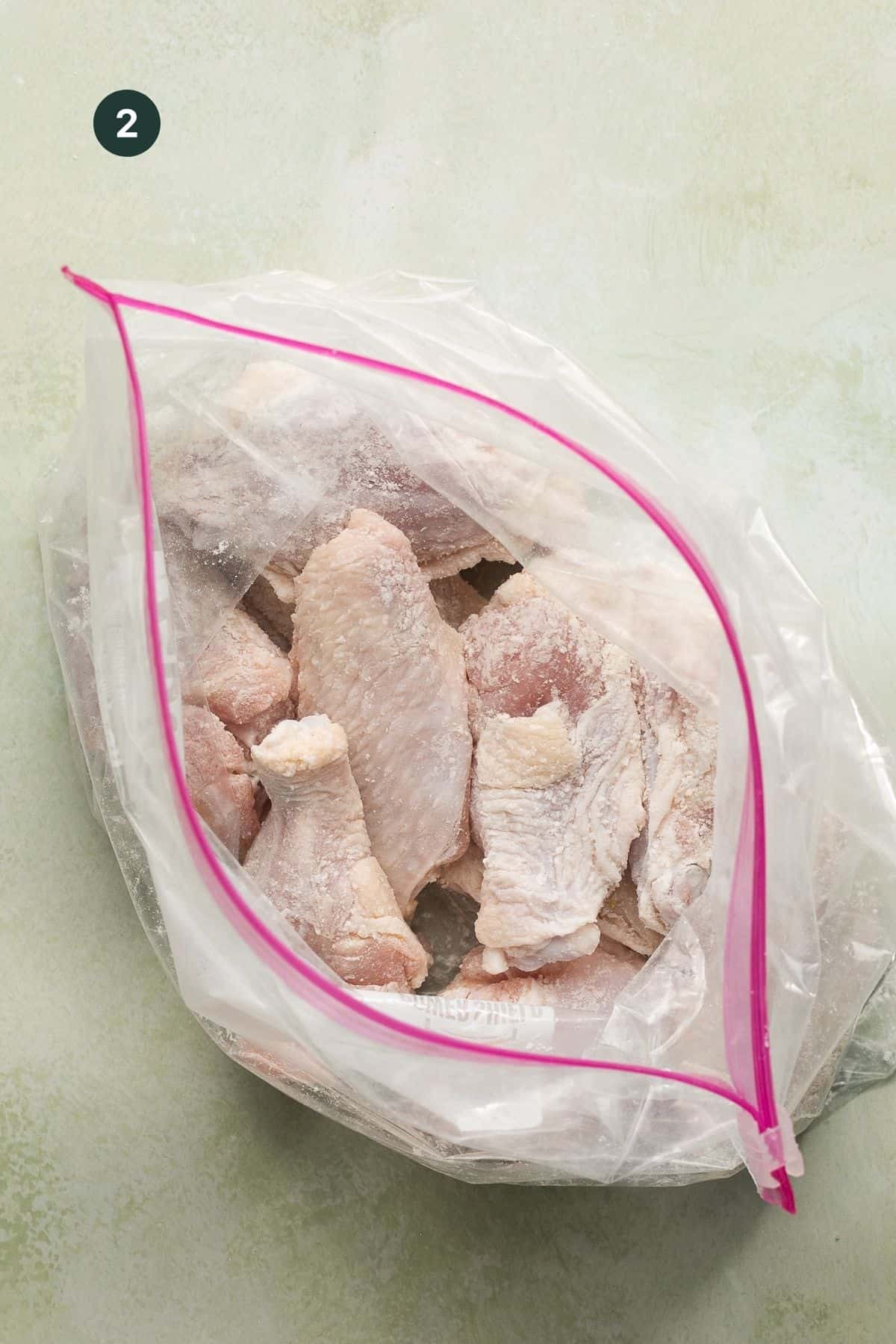 Wings in a ziplock bag coated with baking powder.
