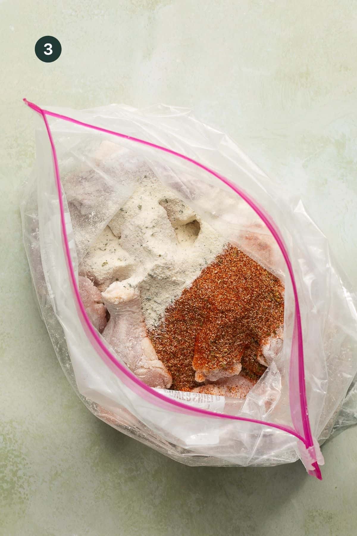 Ranch and cajun seasoning added to the wings in a ziplock bag.