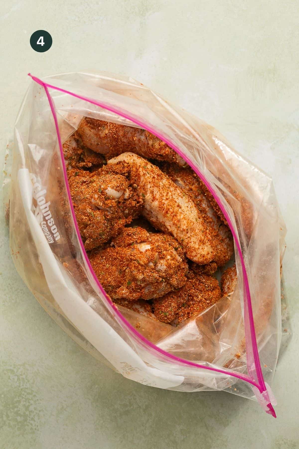 Seasoned and coated wings in a ziplock bag.