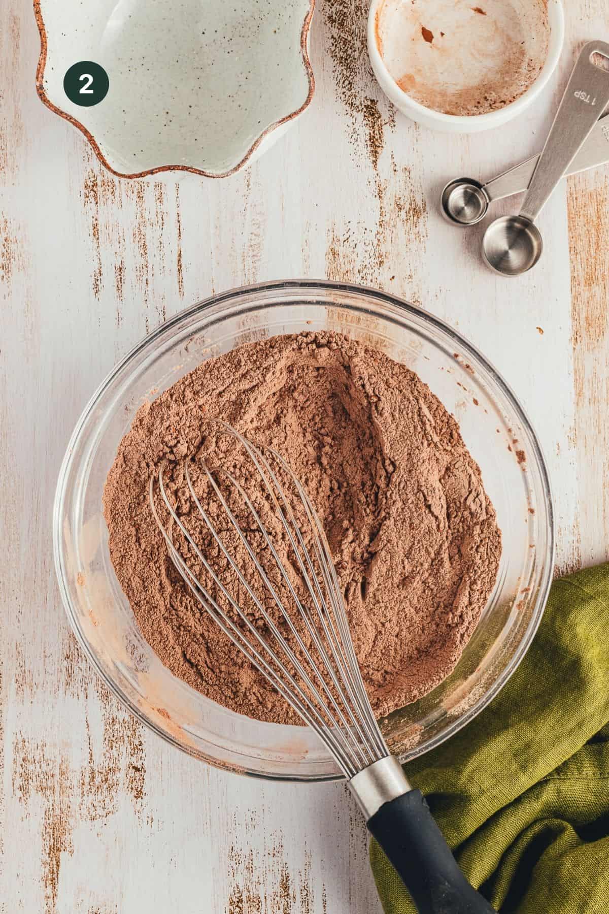 Flour, cocoa powder, salt, baking soda and baking powder in a mixing bowl with a whisk. 