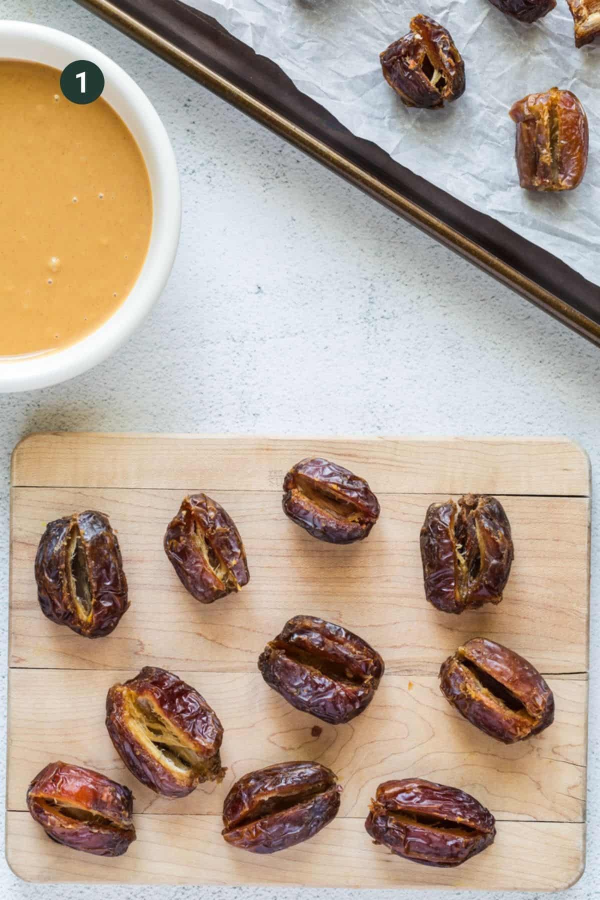 Dates with pit removed and sliced for filling with a small bowl of peanut butter. 