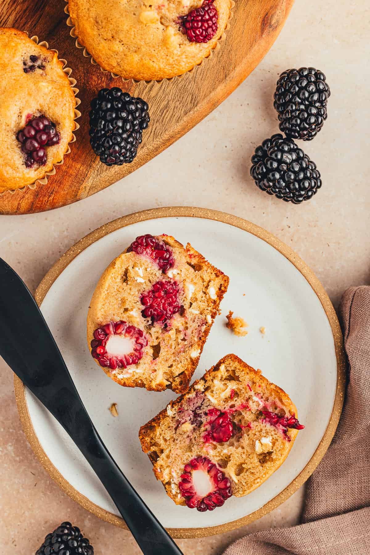 One blackberry oatmeal muffin cut in half showing the inside. 