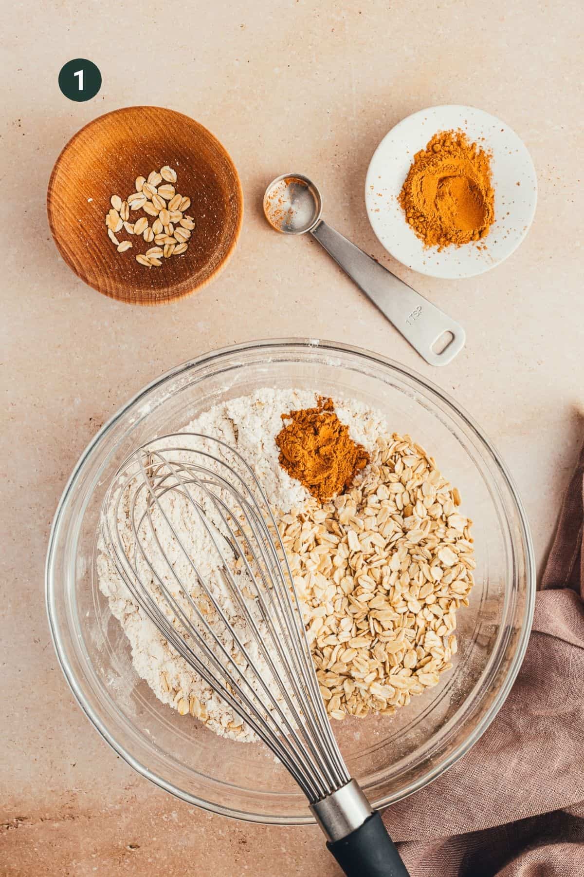 Dry muffin ingredients in a large bowl mixed together with a whisk.