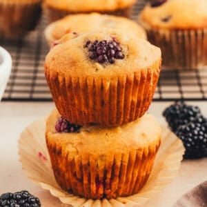 2 muffins stacked with blackberries inside.