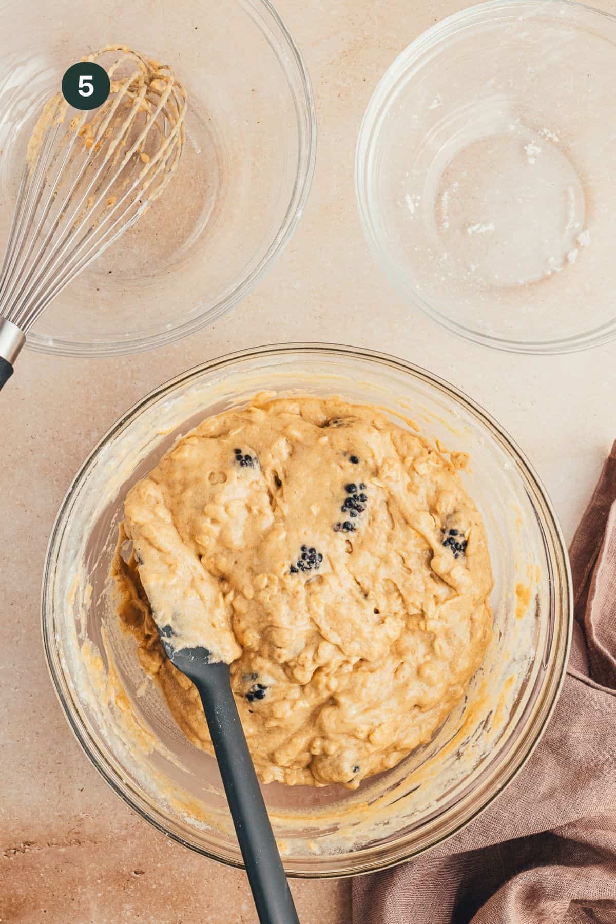 Blackberries folded into muffin batter with a rubber spatula.