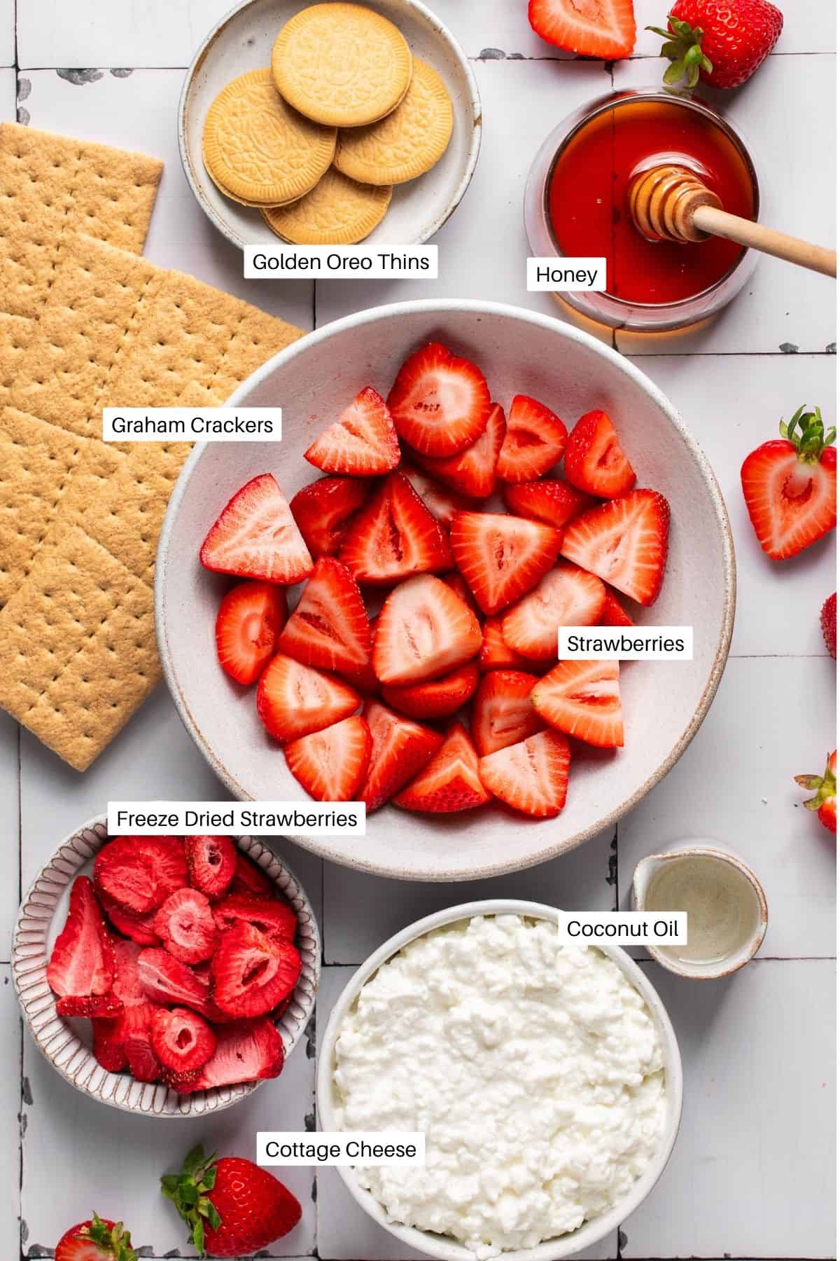 Golden oreo thins, honey, graham crackers, strawberries, freeze dried strawberries, melted coconut oil and cottage cheese for ice cream bars.