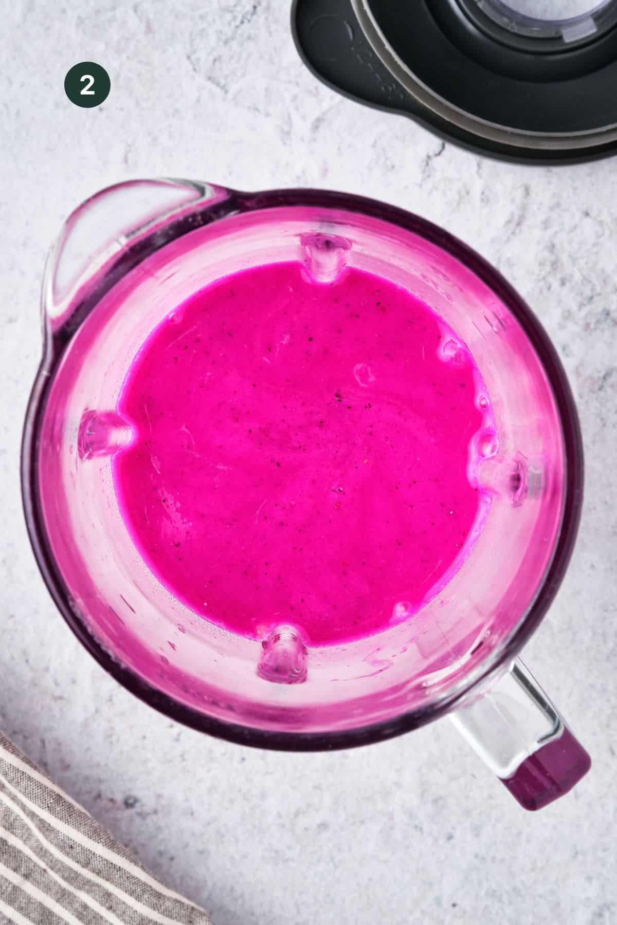 Fully blended dragon fruit smoothie ingredients in a blender.