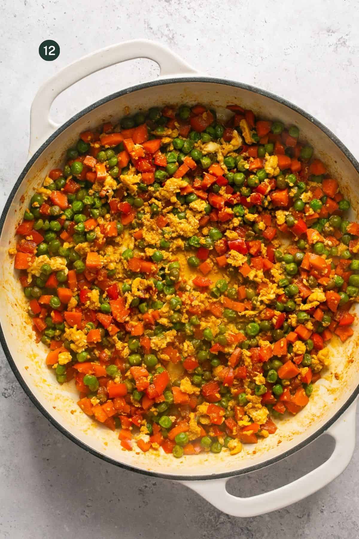 Scrambled eggs mixed into the peas, carrots and bell pepper mixture.