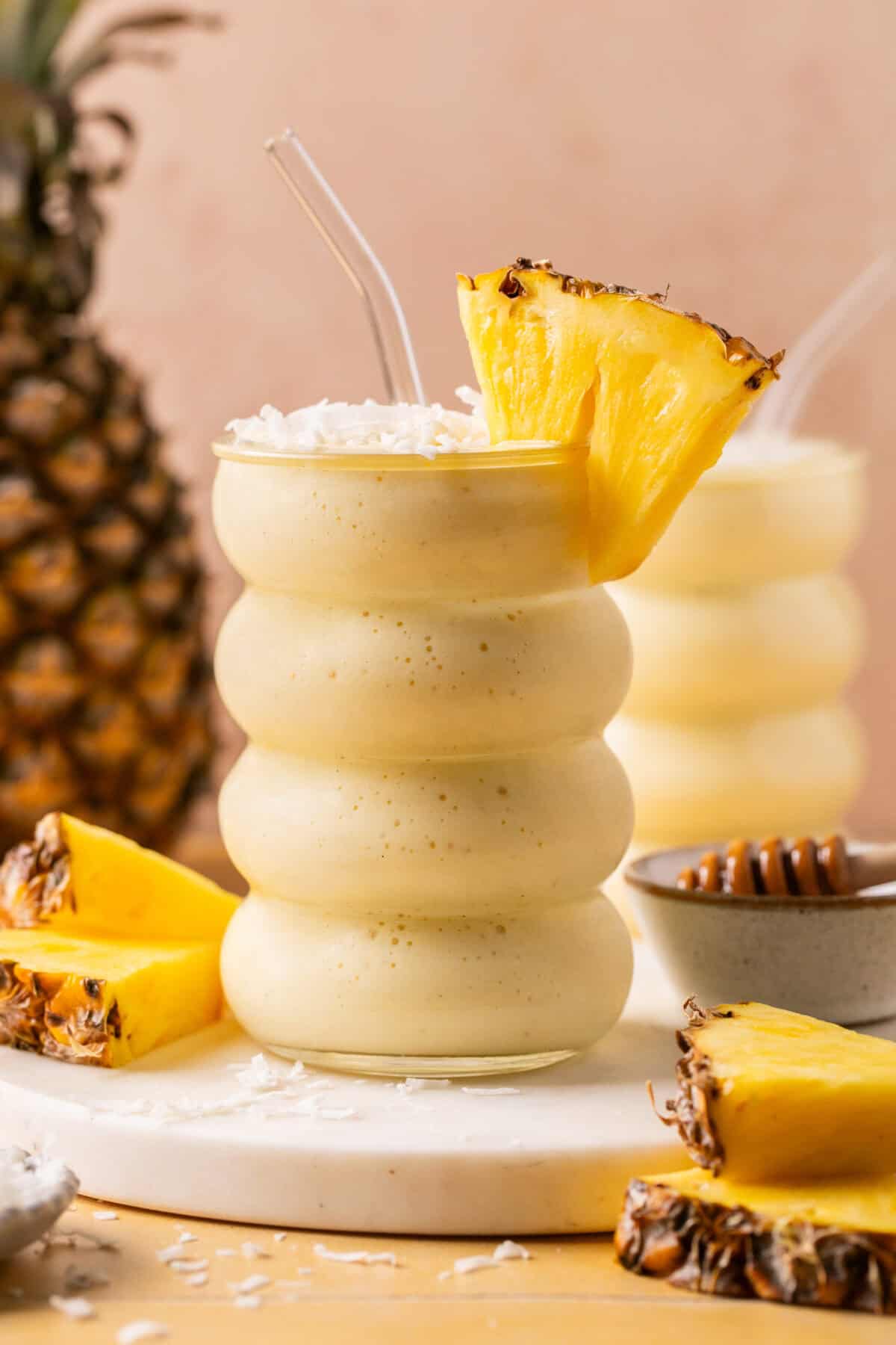 Smoothie topped with fresh pineapple and coconut flakes. 