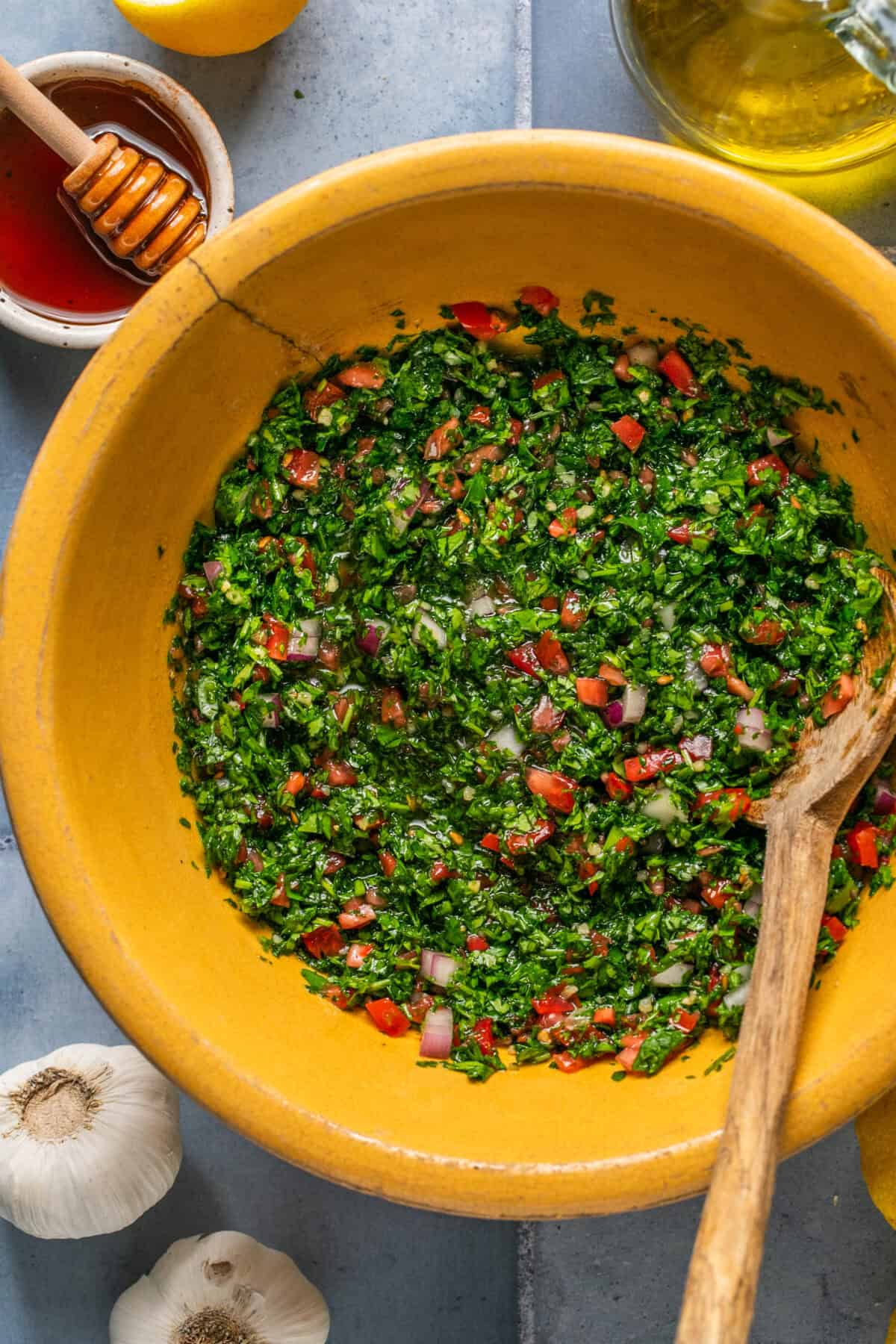 Mixed and combined chimichurri sauce in a mixing bowl ready to place in the fridge to marinate. 