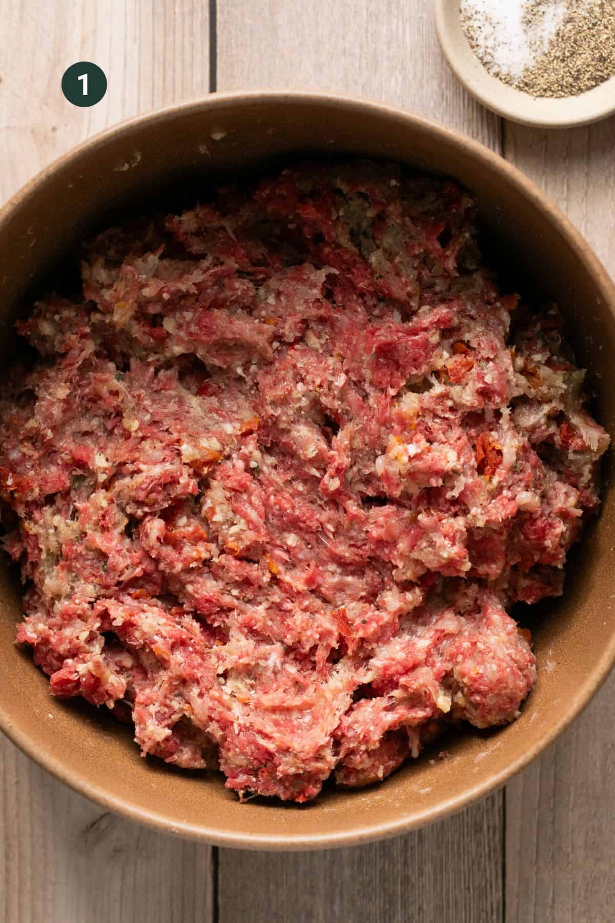 All the meatball ingredients in a large mixing bowl combined. 