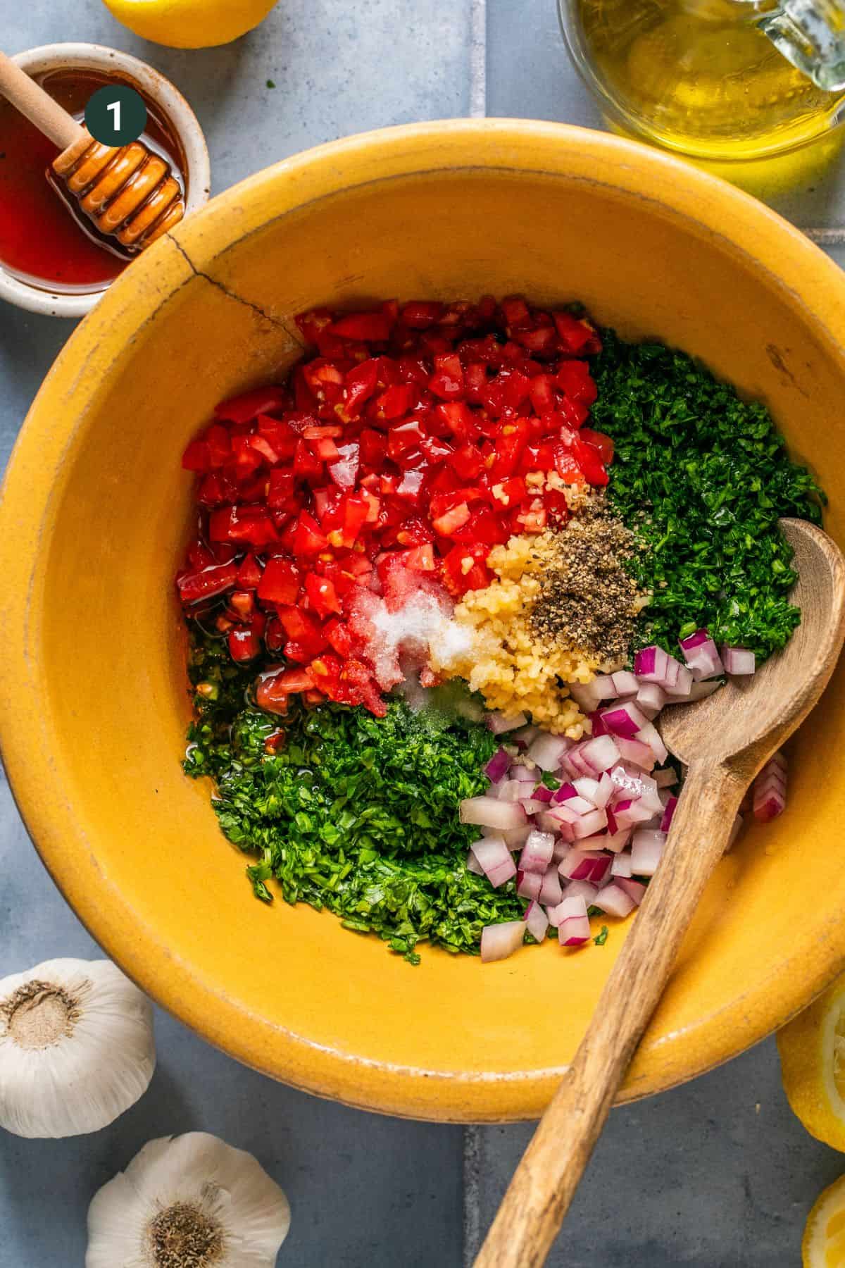 Chopped parsley, cilantro, tomatoes, onion, honey, garlic, salt, pepper and red wine vinegar added to a mixing bowl. 