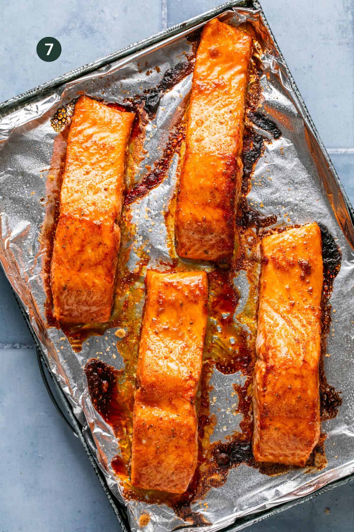 Fully baked salmon in a foil lined baking sheet. 