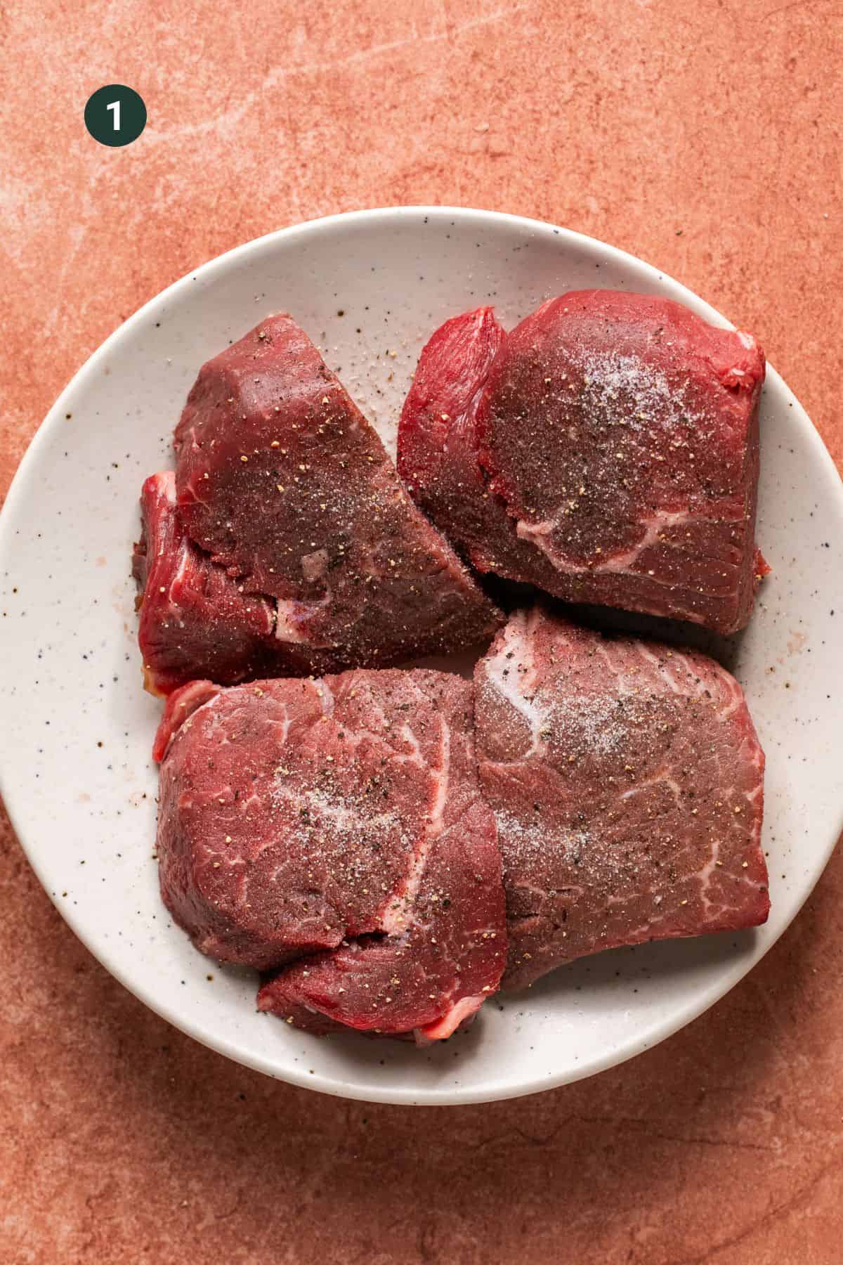 Beef tenderloin cut into 6 oz. filets seasoned with salt and pepper.