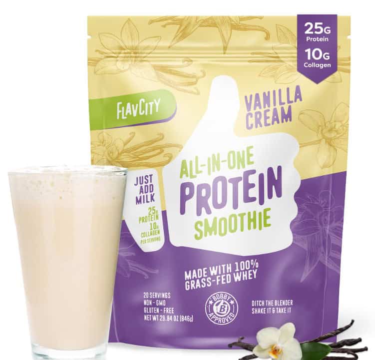 A glass of vanilla cream protein smoothie sits beside a FlavCity Vanilla Cream package boasting 25g Protein, 10g Collagen, and Made with 100% Grass-Fed Whey. Adorned with vanilla flowers and a pod, it's a tempting treat. Don't miss out—explore discount codes for added savings!