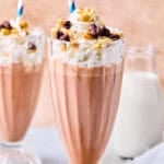 Two glasses of milkshakes with whipped cream and cereal, perfect as a smoothie recipe without banana for those seeking a delicious twist.