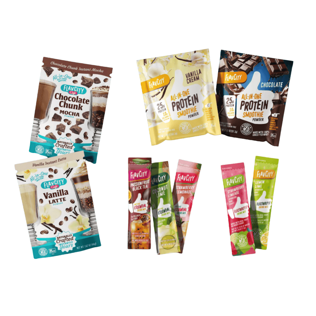 A variety of FlavCity drink powder packets, including Chocolate Chunk Mocha, Vanilla Latte, All-In-One Protein Smoothie (Chocolate and Vanilla Cream), and several stick packs of smoothie and tea flavors.