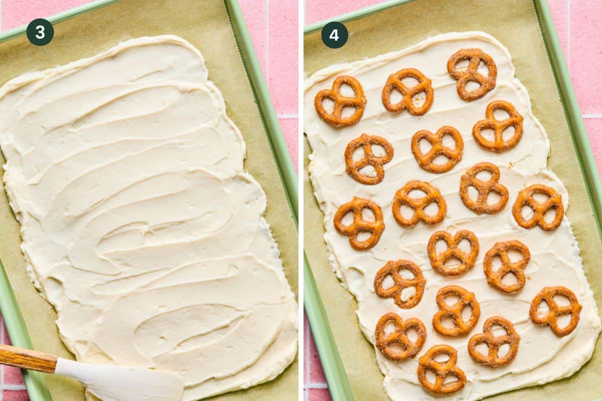 A baking sheet lined with parchment paper. On the left, creamy protein frozen yogurt bark batter is spread with a spatula. On the right, the batter is topped with rows of mini pretzels, evenly spaced.