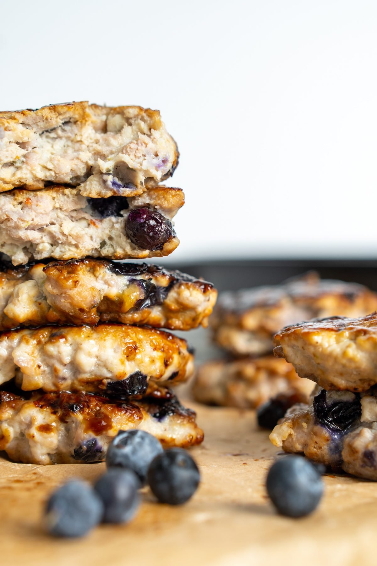 Stack of blueberry breakfast sausage, some of which are missing bites.