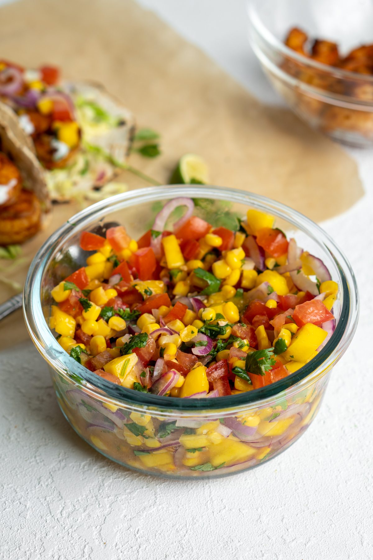 Mango corn salsa in a glass bowl.