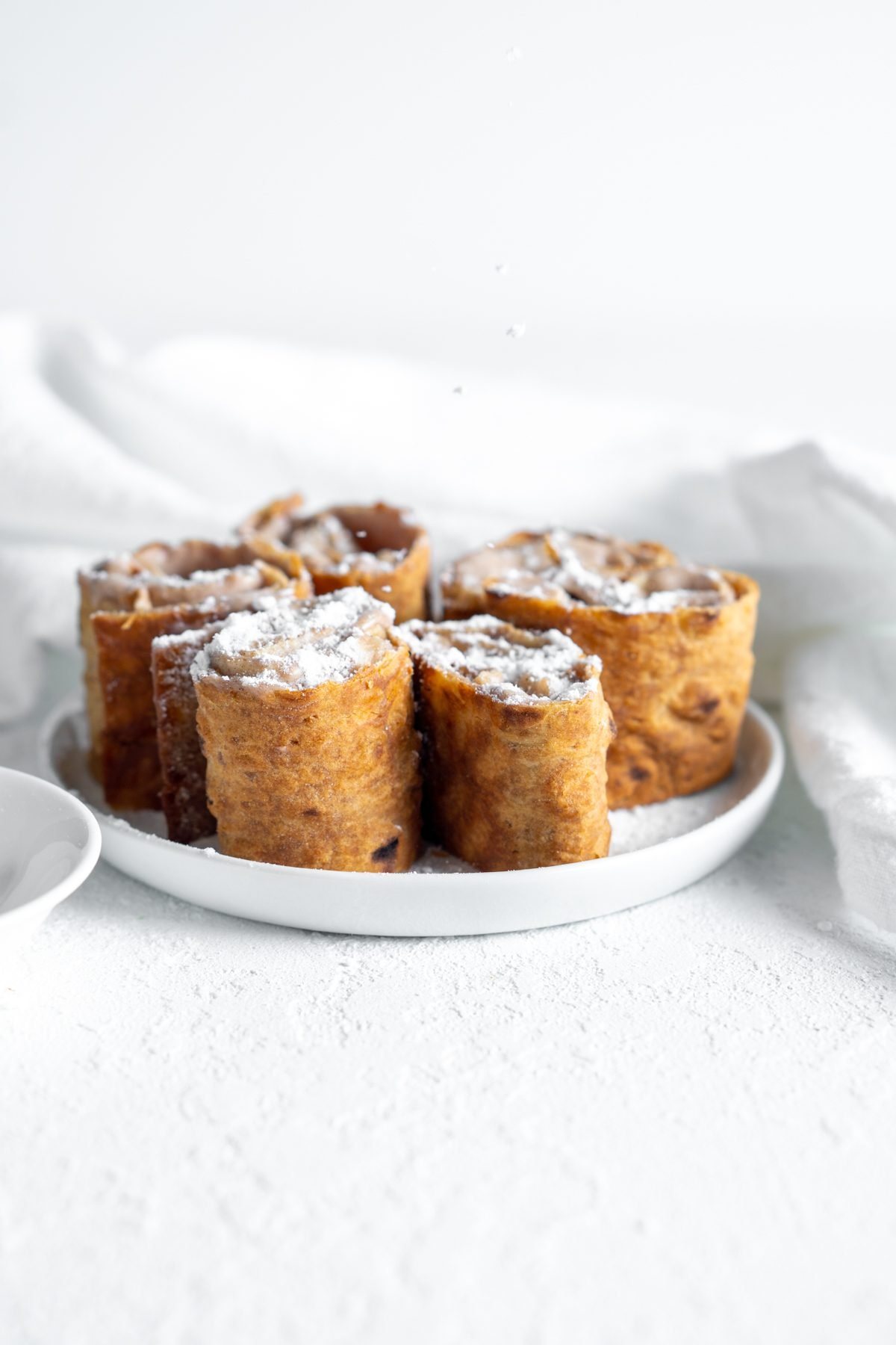 Cinnamon Cream Cheese Roll Ups topped with powdered sugar.