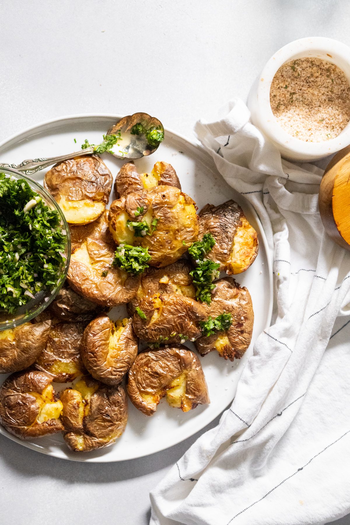 Smashed potatoes drizzled with chimichurri sauce.