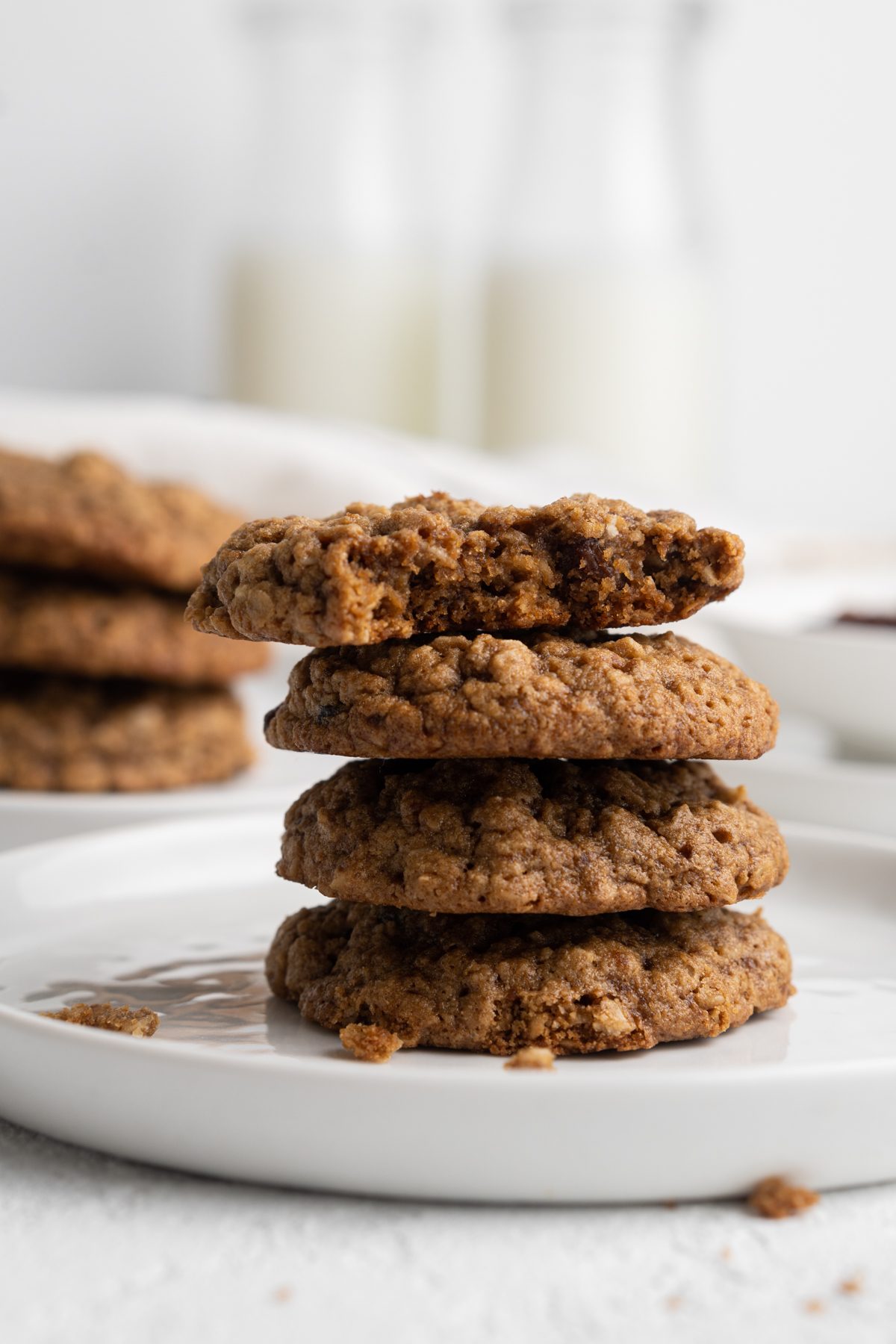 Stack of maple oatmeal cookies, one of which is missing a bite.