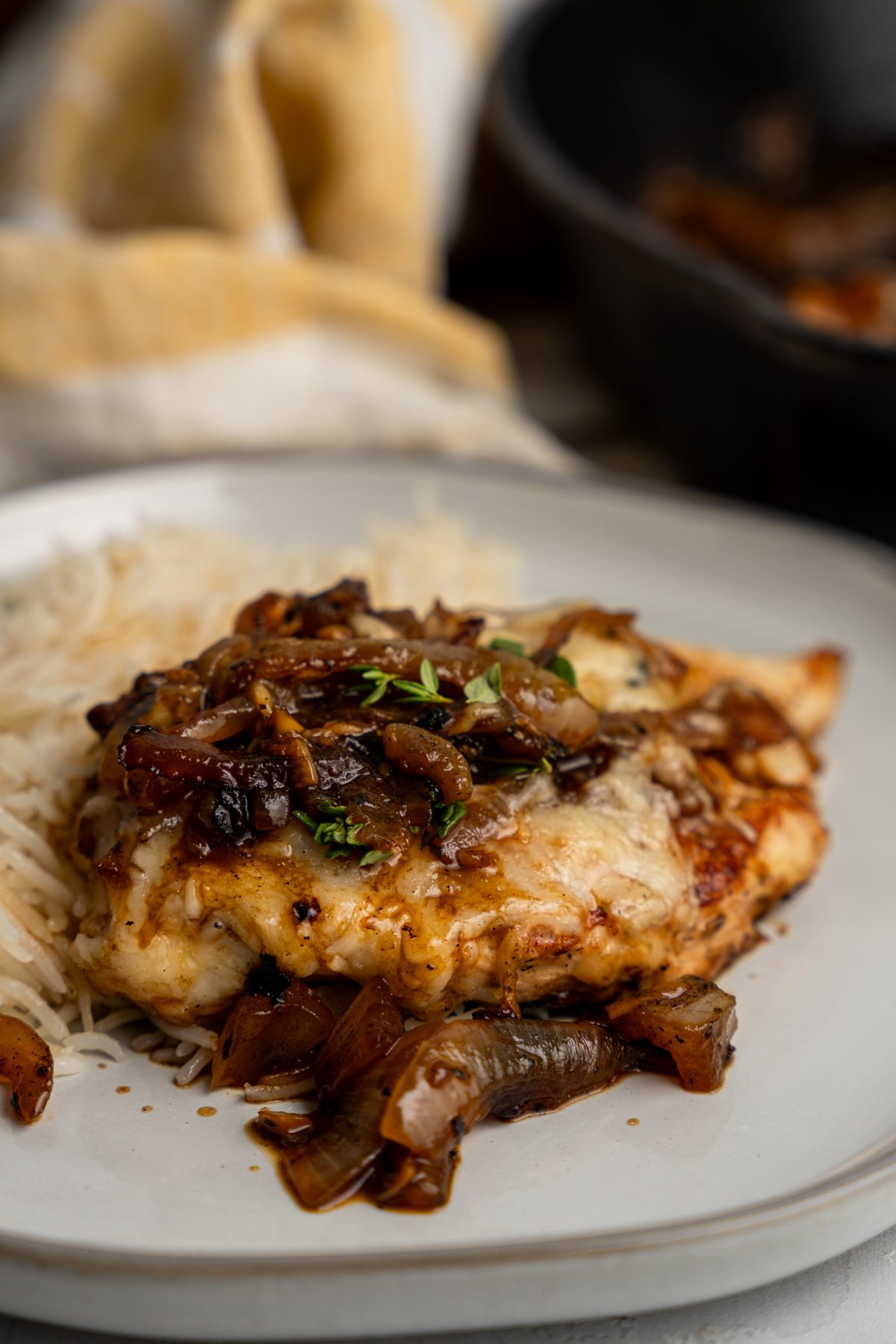 French onion chicken on a plate with rice.