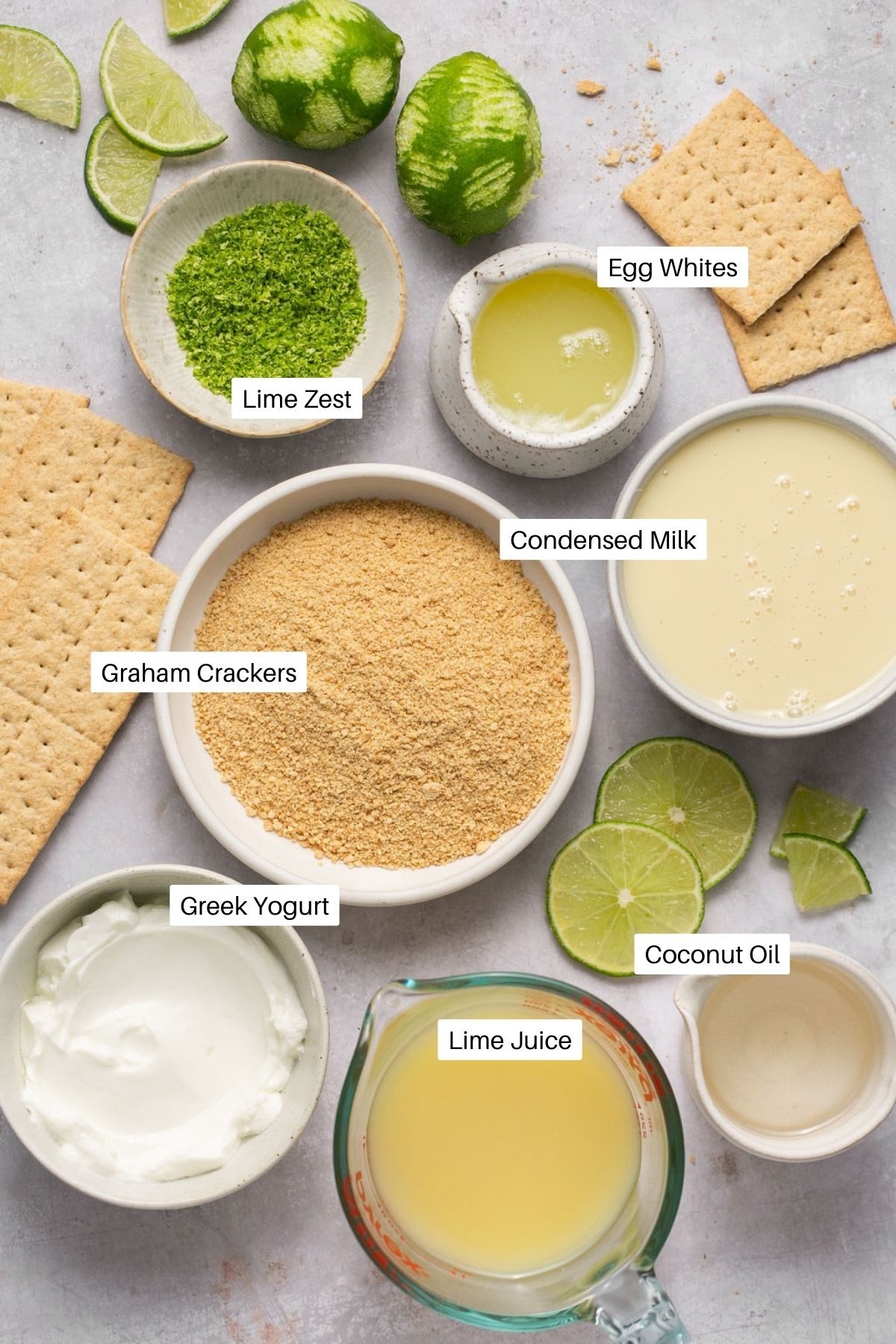 Ingredients for key lime pie bars including graham crackers, Greek yogurt, and condensed milk.
