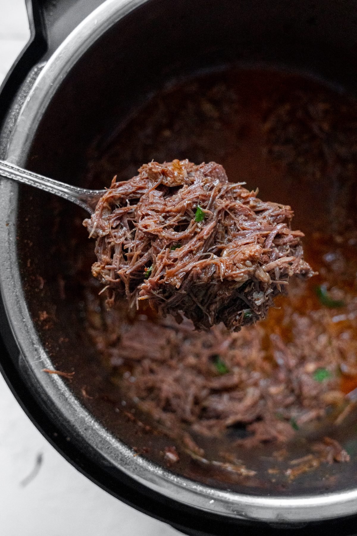 Shredded beef on a spoon.