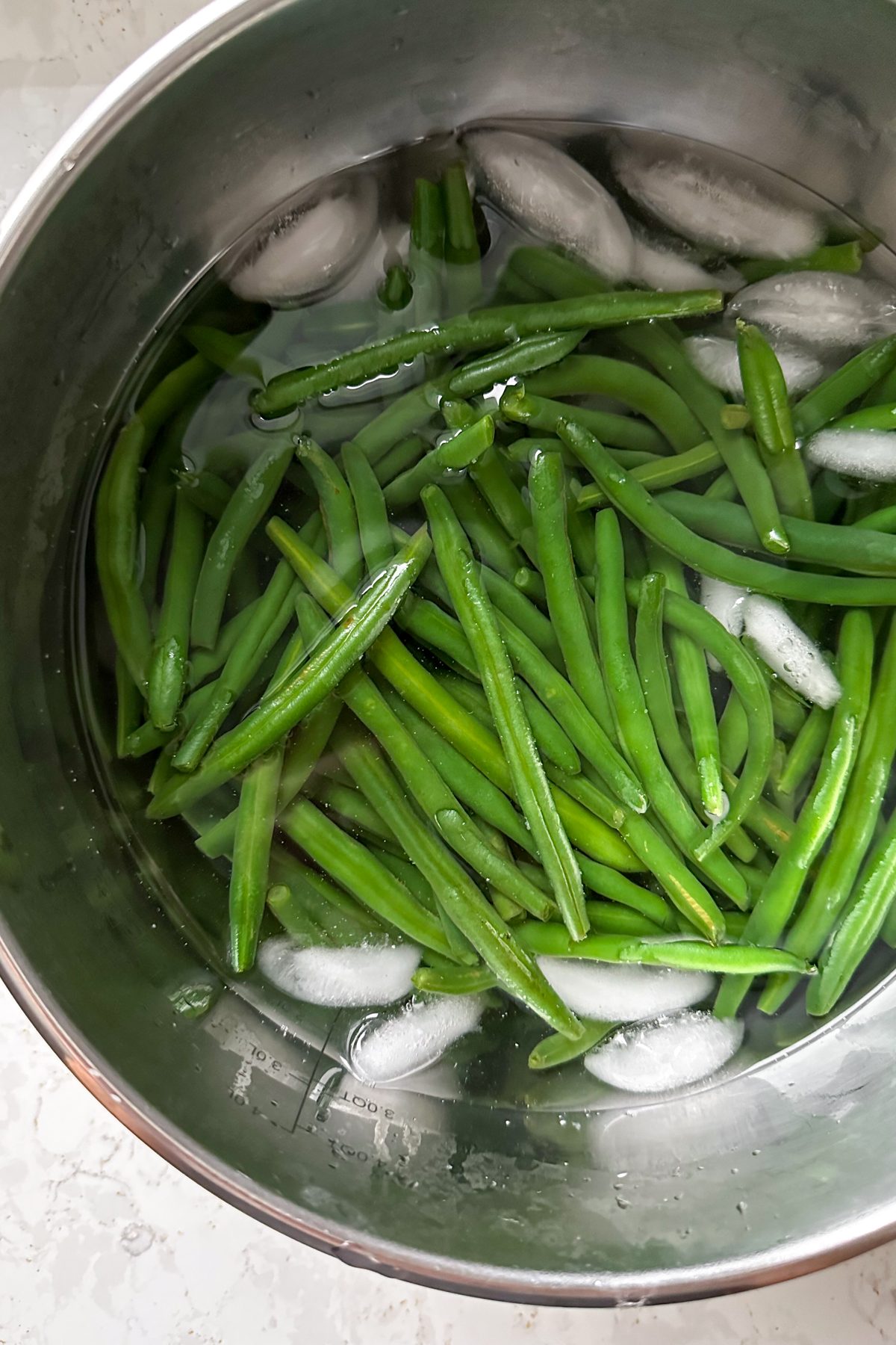 Green beans in a bowl of ice water. 