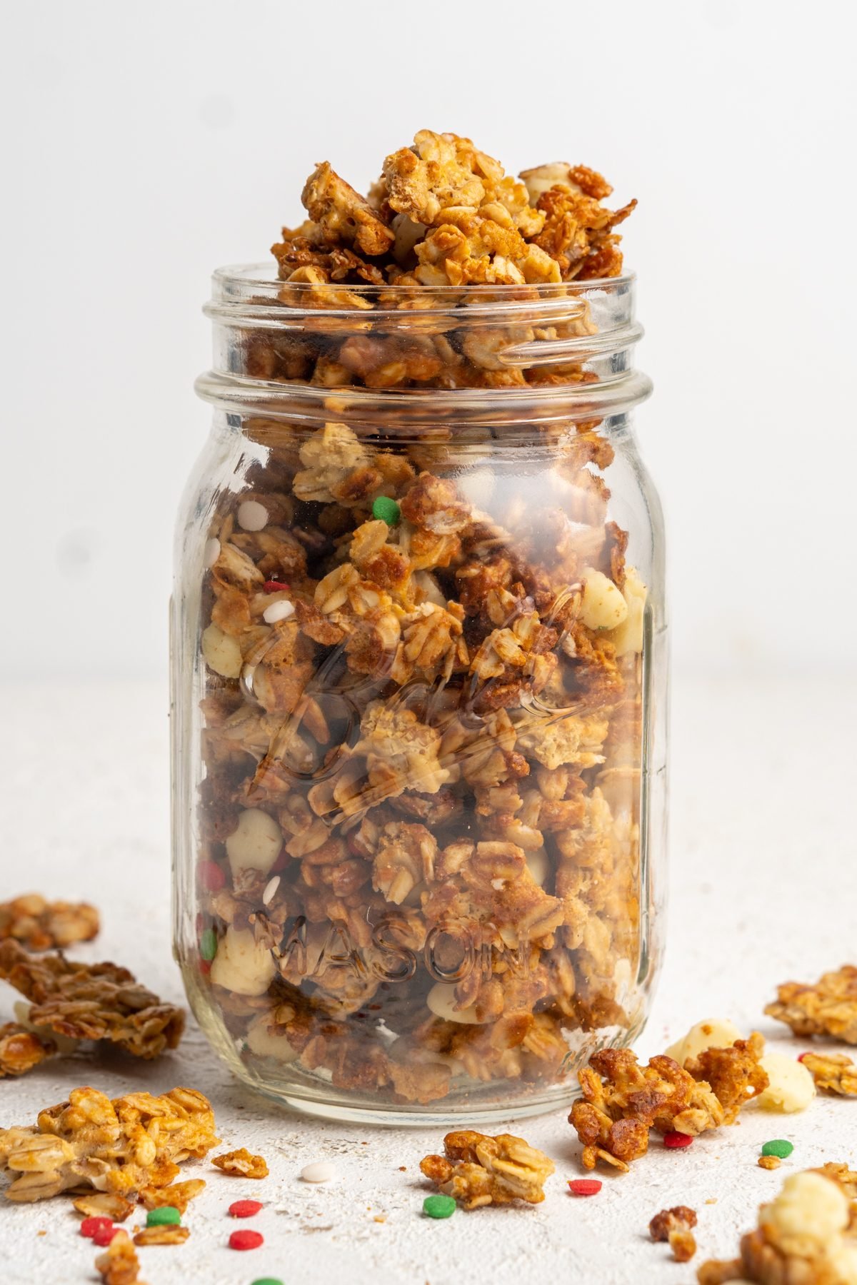 Overflowing jar of Peppermint White Chocolate Granola.