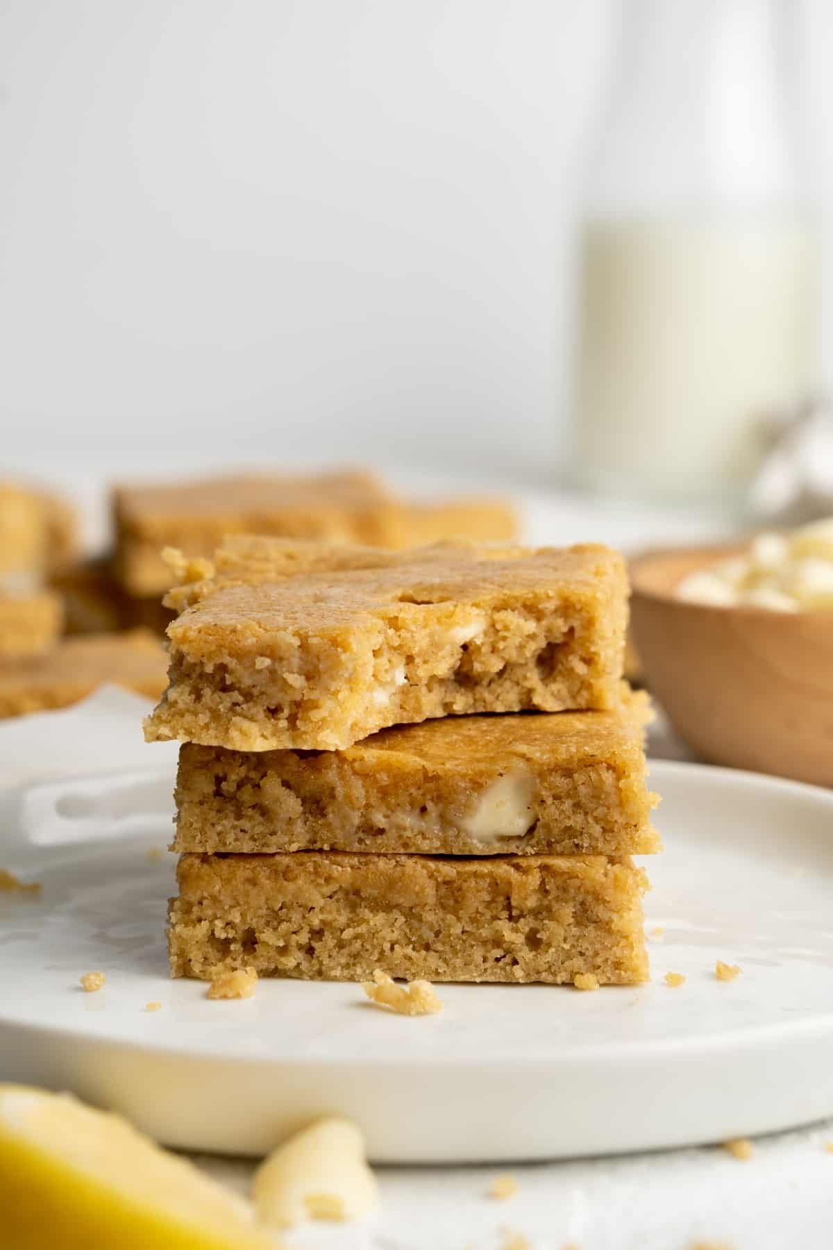 Stack of lemon blondies, one of which is missing a bite.