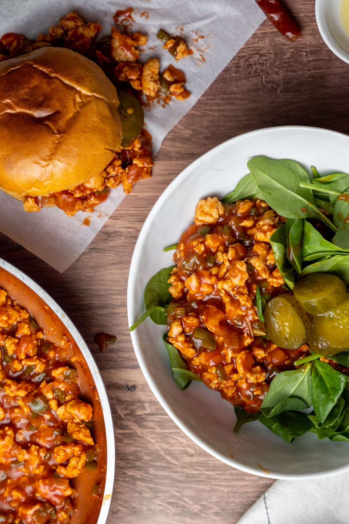 Ground chicken sloppy joe mix on a plate with greens.