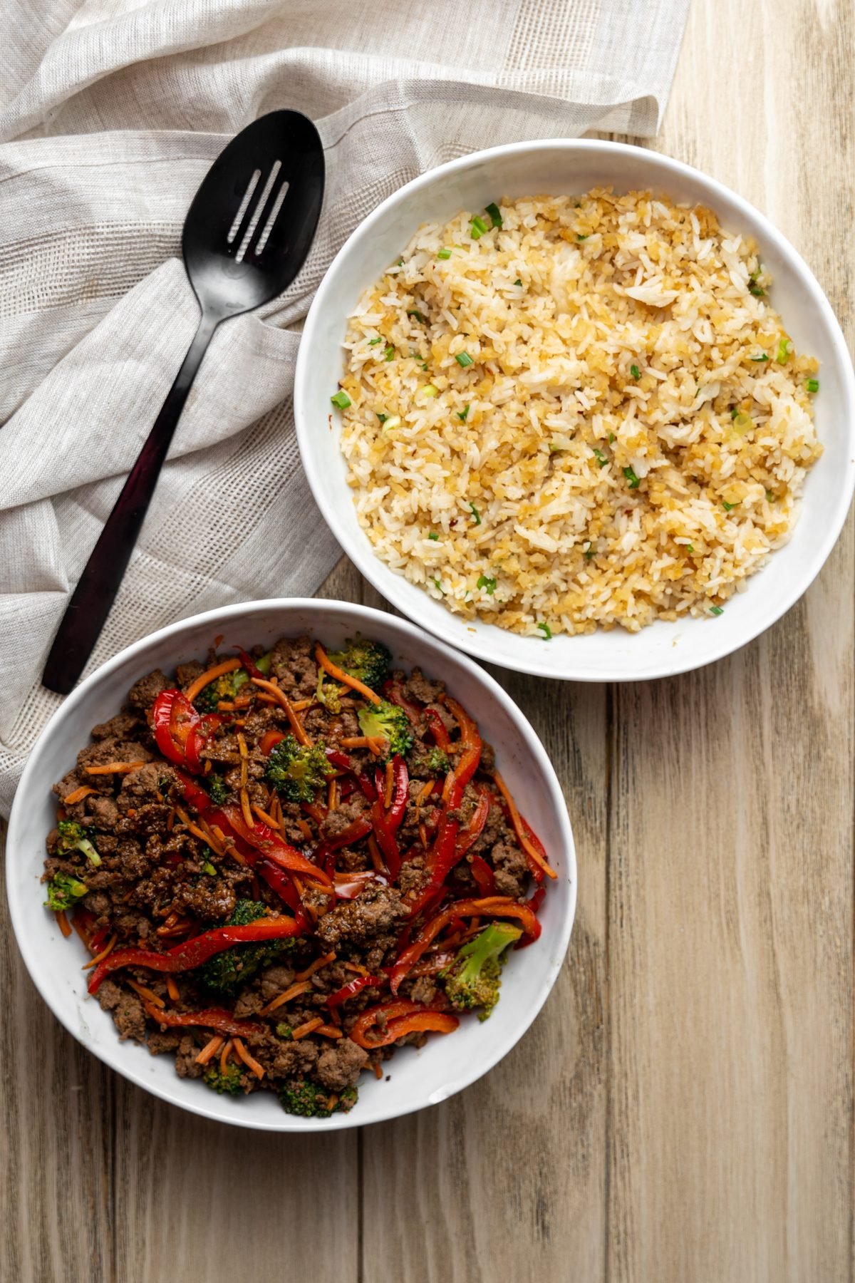 Two bowl - one with teriyaki beef and vegetables, the other with rice blend.